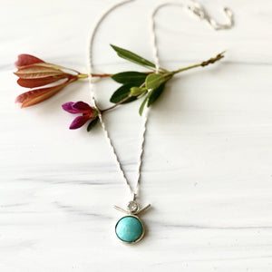 Sterling Silver Necklace with Amazonite and White Topaz on marble background with rose flower